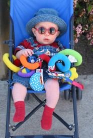 Joël in his stroller, wearing sunglasses